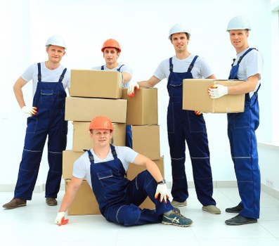 Local movers handling furniture on a Notting Hill street