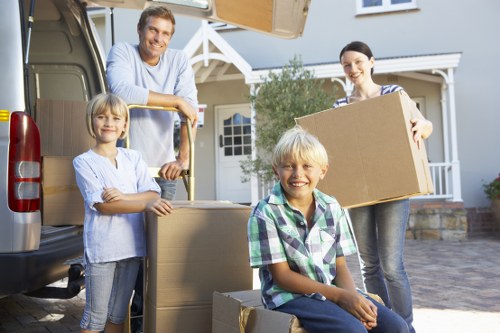 Staff using PPE while moving furniture with care
