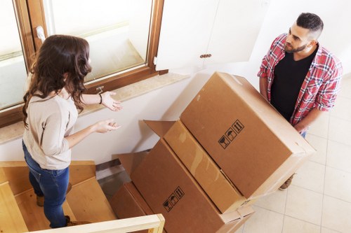 Team loading household items from a flat with stair access