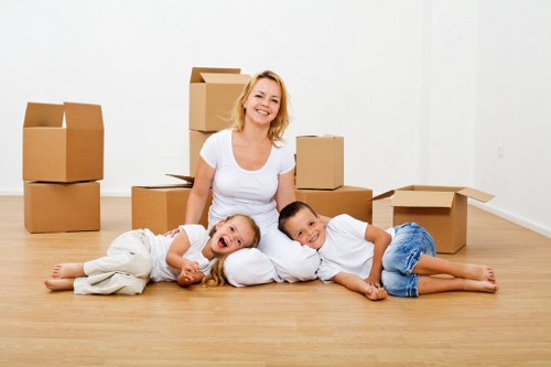 Professional movers handling furniture carefully in a period property